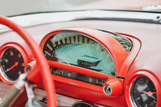 Interior of red vintage car and speedometer