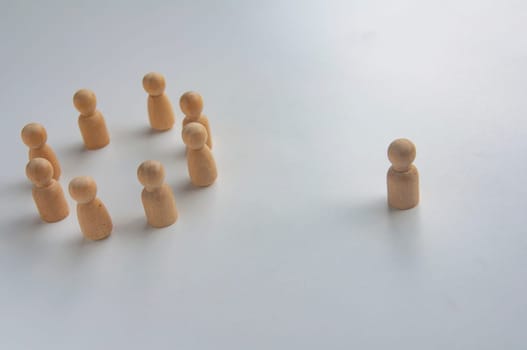 A wooden figure isolated from the rest of the wooden figures.