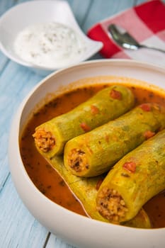 Recipe of stuffed courgette with tomato sauce, Lebanese style, Kouca Mehchi bi Banadoura, with Greek yogurt. High quality photo