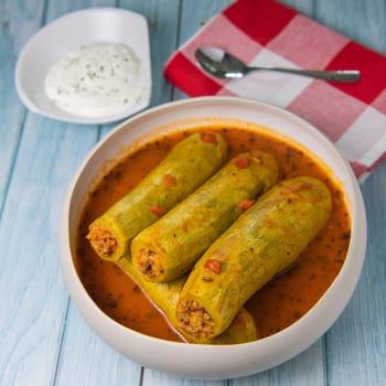 Recipe of stuffed courgette with tomato sauce, Lebanese style, Kouca Mehchi bi Banadoura, with Greek yogurt. High quality photo