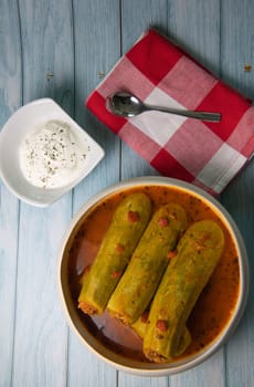 Recipe of stuffed courgette with tomato sauce, Lebanese style, Kouca Mehchi bi Banadoura, with Greek yogurt. High quality photo