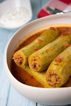 Recipe of stuffed courgette with tomato sauce, Lebanese style, Kouca Mehchi bi Banadoura, with Greek yogurt. High quality photo