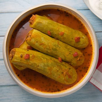 Recipe of stuffed courgette with tomato sauce, Lebanese style, Kouca Mehchi bi Banadoura, with Greek yogurt. High quality photo