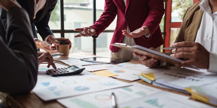 Close up of Diverse colleagues gather brainstorm discuss financial statistics at office meeting. finance, teamwork, Big data Graphs Charts concept.