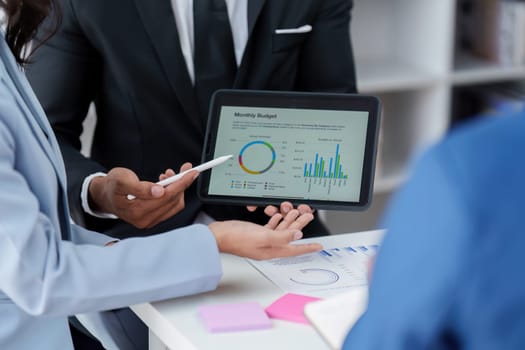 Close up of Diverse colleagues gather brainstorm discuss financial statistics at office meeting. finance, teamwork, Big data Graphs Charts concept.