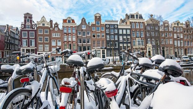City scenic from a snowy Amsterdam in winter in the Netherlands