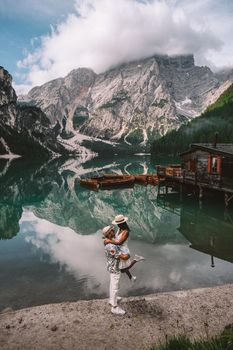 couple on vacation in the Italian Dolomites, Beautiful lake in the Italian Alps, Lago di Braies. 