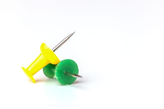 Push pins on white background for the concept of office and school stationary object.