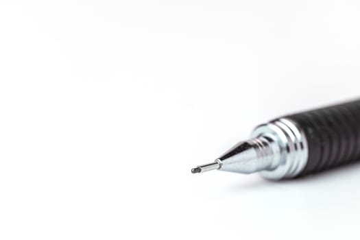 Closeup image of the pointed end part of a mechanical pencil on white background for the concept of office and school stationary.