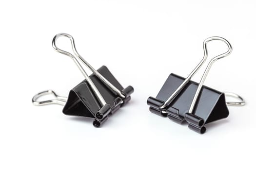 Binder clips on white background for the concept of office and school stationary.