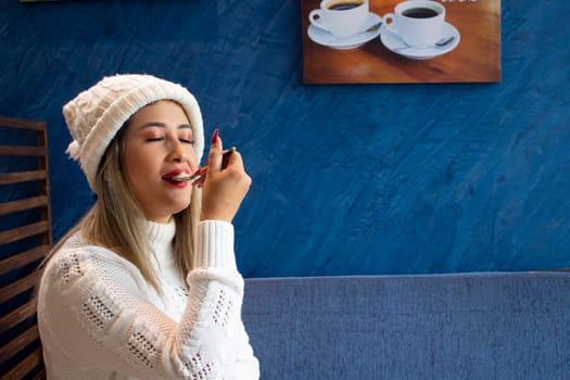 girl sitting with a face of pleasure relishing a cake with a spoon. High quality photo