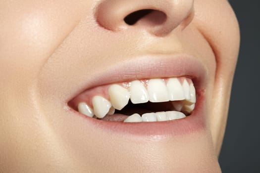 Cropped half face portrait of woman. Closeup Dental Beauty. Beautiful Macro with perfect White Teeth. Sexy Fashion Lips Red Make-up. Whitening Tooth and Wellness Treatment