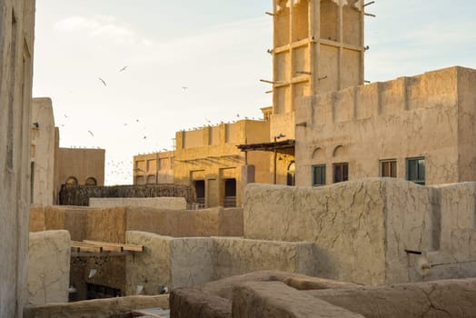 Narrow streets that create shade on a hot day in the old city of Dubai Creek and Bur district. Travel destinations and heritage village.