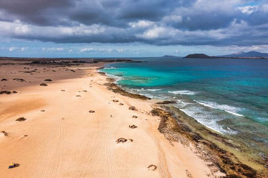 Aerial view of beach in Corralejo Park, Fuerteventura, Canary Islands. Corralejo Beach (Grandes Playas de Corralejo) on Fuerteventura, Canary Islands, Spain. Beautiful turquoise water and white sand.
