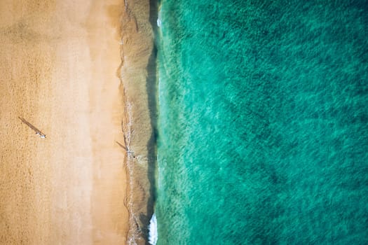 Beach with turquoise water on Fuerteventura island, Spain, Canary islands. Aerial view of sand beach, ocean texture background, top down view of beach by drone. Fuerteventura, Spain, Canary islands.