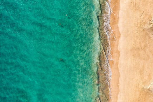 Beach with turquoise water on Fuerteventura island, Spain, Canary islands. Aerial view of sand beach, ocean texture background, top down view of beach by drone. Fuerteventura, Spain, Canary islands.