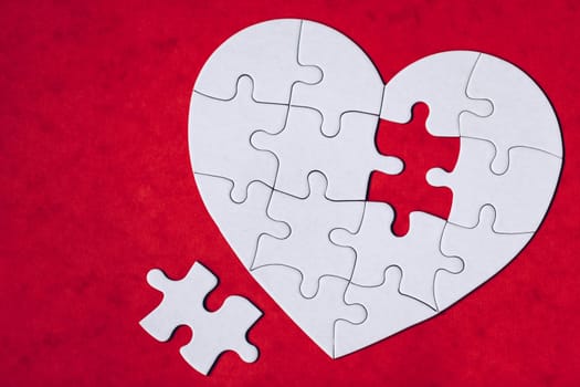 Heart object made of puzzle pieces. Make complete heart. Jigsaw puzzle pieces in form of heart. Happy Valentines Day, greeting card template. Heart jigsaw puzzle.