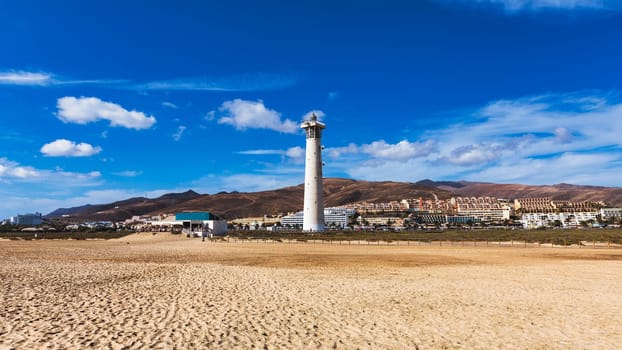 Lighthouse on Morro Jable beach on Jandia peninsula in sunrise light, Fuerteventura, Canary Islands, Spain. Faro de Morro Jable Lighthouse, Fuerteventura.