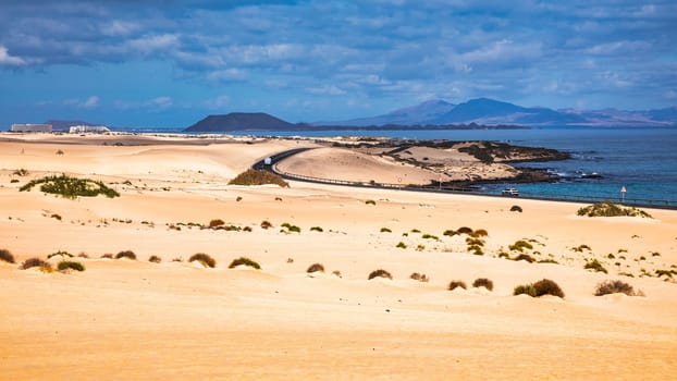 Sand dunes, Las Dunas de Corralejo, Corralejo Natural Park, dramatic cloud formation, Fuerteventura, Canary Islands, Spain. Sand dunes landscape, Corralejo, Fuerteventura, Canary Islands, Spain.