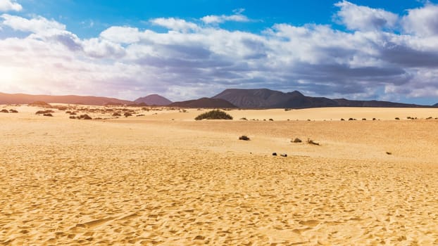Sand dunes, Las Dunas de Corralejo, Corralejo Natural Park, dramatic cloud formation, Fuerteventura, Canary Islands, Spain. Sand dunes landscape, Corralejo, Fuerteventura, Canary Islands, Spain.