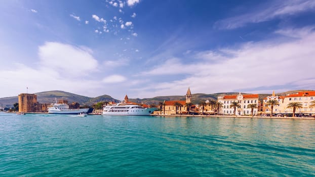 View at town Trogir, old touristic place in Croatia Europe with seagull's flying over city. Trogir town coastal view. Magnificent Trogir, Croatia. Sunny old Venetian town, Dalmatian Coast in Croatia.