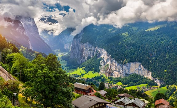 Famous Lauterbrunnen town and Staubbach waterfall, Bernese Oberland, Switzerland, Europe. Lauterbrunnen valley, Village of Lauterbrunnen, the Staubbach Fall, and the Lauterbrunnen Wall in Swiss Alps.