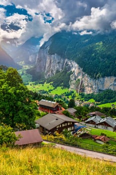 Lauterbrunnen valley with famous church and Staubbach waterfall. Lauterbrunnen village, Berner Oberland, Switzerland, Europe. Spectacular view of Lauterbrunnen valley in a sunny day, Switzerland.