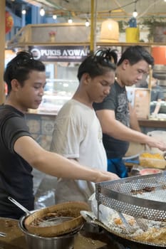 Jakarta,Indonesia. April 23, 2023. Men frying fried Cempedak at Petak 6, Glodok. During Eid Holidays. Street Photography.