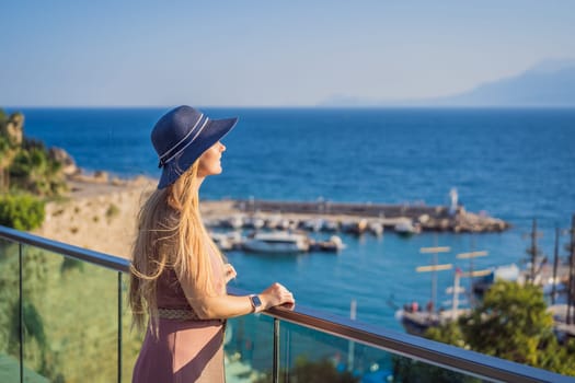 Woman tourist in Old town Kaleici in Antalya. Turkiye. Panoramic view of Antalya Old Town port, Taurus mountains and Mediterrranean Sea, Turkey.