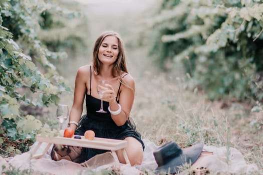 Picnic and wine tasting at sunset in the hills of Italy, Tuscany. Vineyards and open nature in the summer. Romantic dinner, fruit and wine.