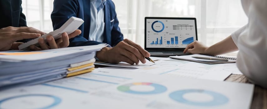 Business People Meeting using laptop computer,calculator,notebook,stock market chart paper for analysis Plans to improve quality next month. Conference Discussion Corporate Concept....