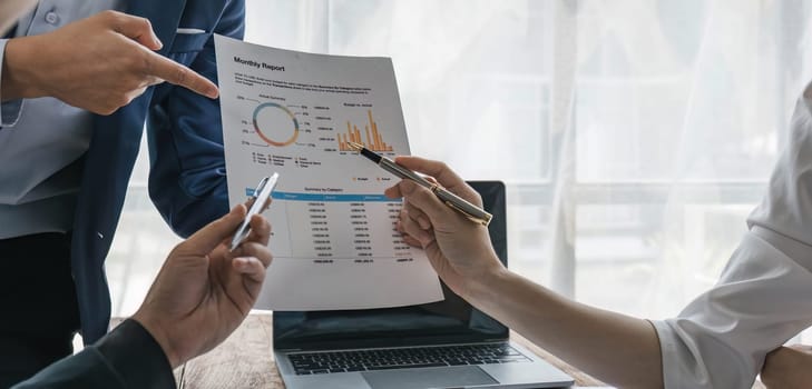 Business People Meeting using laptop computer,calculator,notebook,stock market chart paper for analysis Plans to improve quality next month. Conference Discussion Corporate Concept....