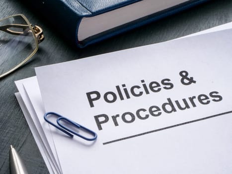 Documents about policies and procedures are on table.