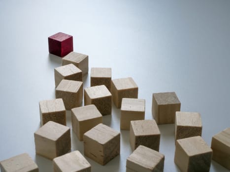 Red cube symbolizes the leader ahead of the others. Leadership concept.