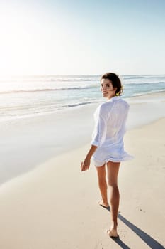 Romance me with walks on the beach. a beautiful young woman enjoying her day at the beach