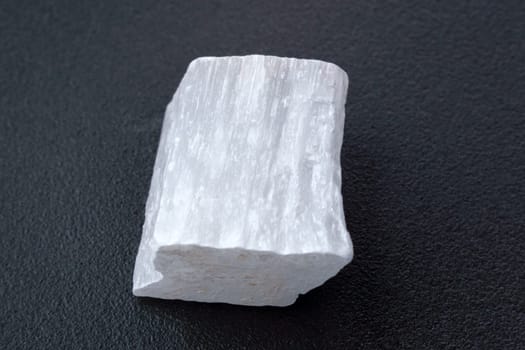 White selenite, variety of the mineral gypsum, zen meditation stones, black background