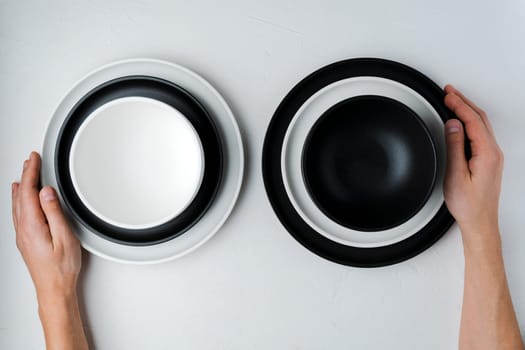 White and black food is an empty ceramic dish on a concrete background. Top View