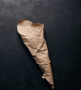 Empty bag of brown craft paper on a black background