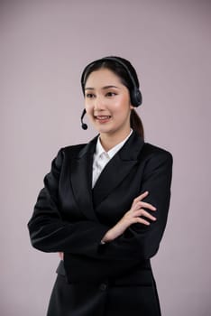 Attractive asian female call center operator with happy smile face advertises job opportunity on empty space, wearing a formal suit and headset on customizable isolated background. Enthusiastic