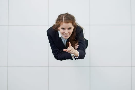 Portrait of a smiling girl with arms crossed from above