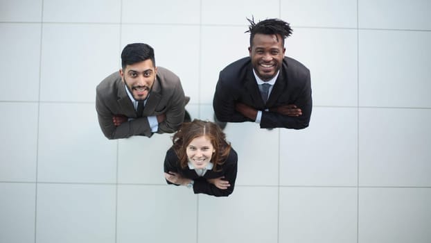 three young people looking at camera up
