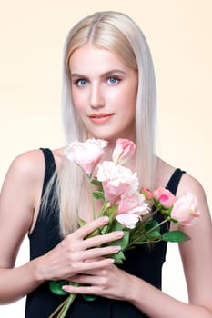 Closeup young personable woman with natural makeup and healthy soft skin holding rose for beauty care advertising in isolated background. Beautiful pretty model girl with flower concept.