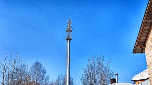 Close up of antenna repeater tower on blue sky in a spring day