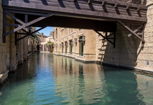 Waterway with old wooden bridge in the Souk Madinat Junction mall