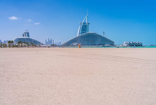 View from Jumeirah public beach of the construction of Marsa al Arab hotel with Burj al Arab behind on coast of Dubai