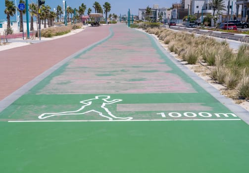 Jogging sign for the green Zero Point running track at Jumeirah public beach in Dubai UAE