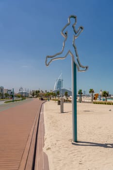 Jogging sign for the green running track at Jumeirah public beach in Dubai UAE
