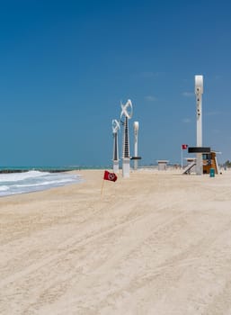 Towers with floodlights and lighting for night swimming at Jumeirah Wild Beach in Dubai