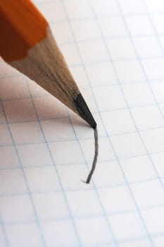 Writing with pencil on white paper close up