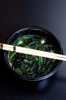 Japanese soup and sticks on a wooden table